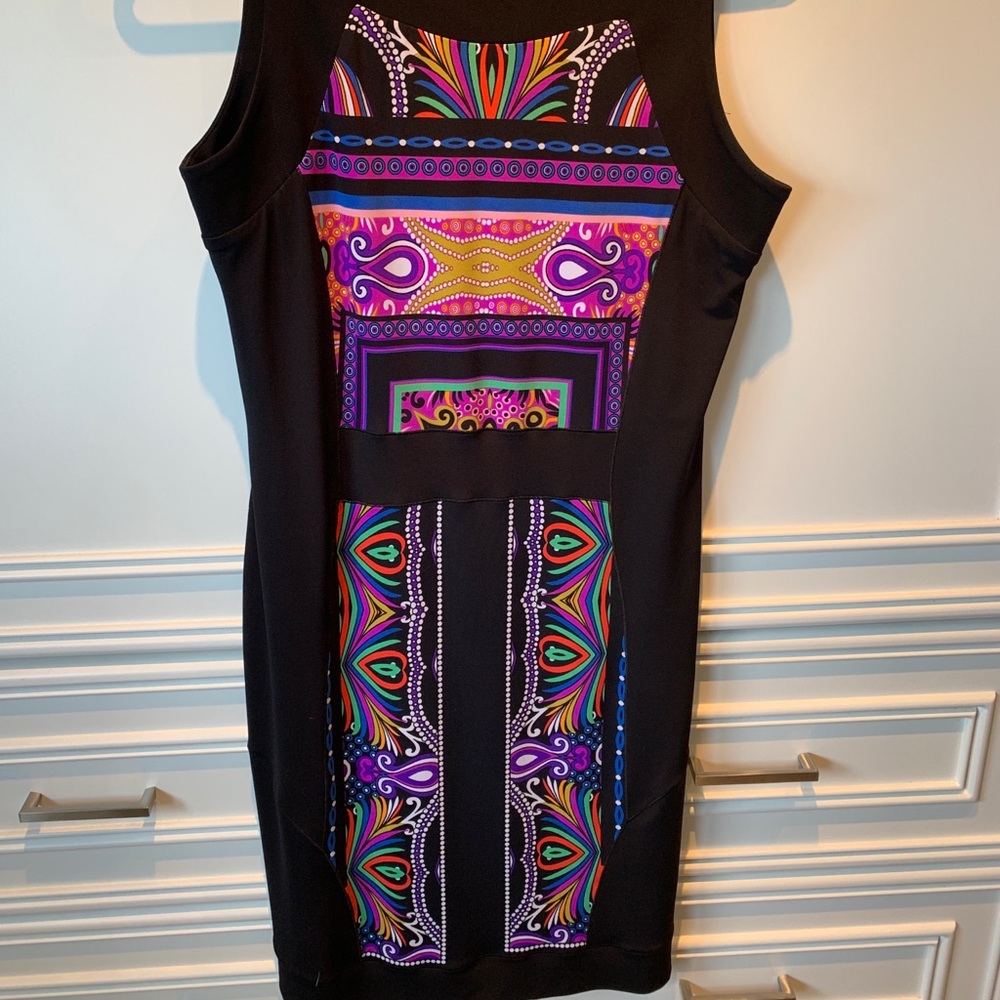 Black knee length dress with colourful design.